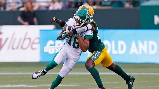 Jun 11, 2023; Edmonton, Alberta, CAN; Edmonton Elks defensive back Kai Gray (29) tackles Saskatchewan Roughriders wide receiver Derek Walker (18) during the first half at Commonwealth Stadium. Mandatory Credit: Perry Nelson-USA TODAY Sports  